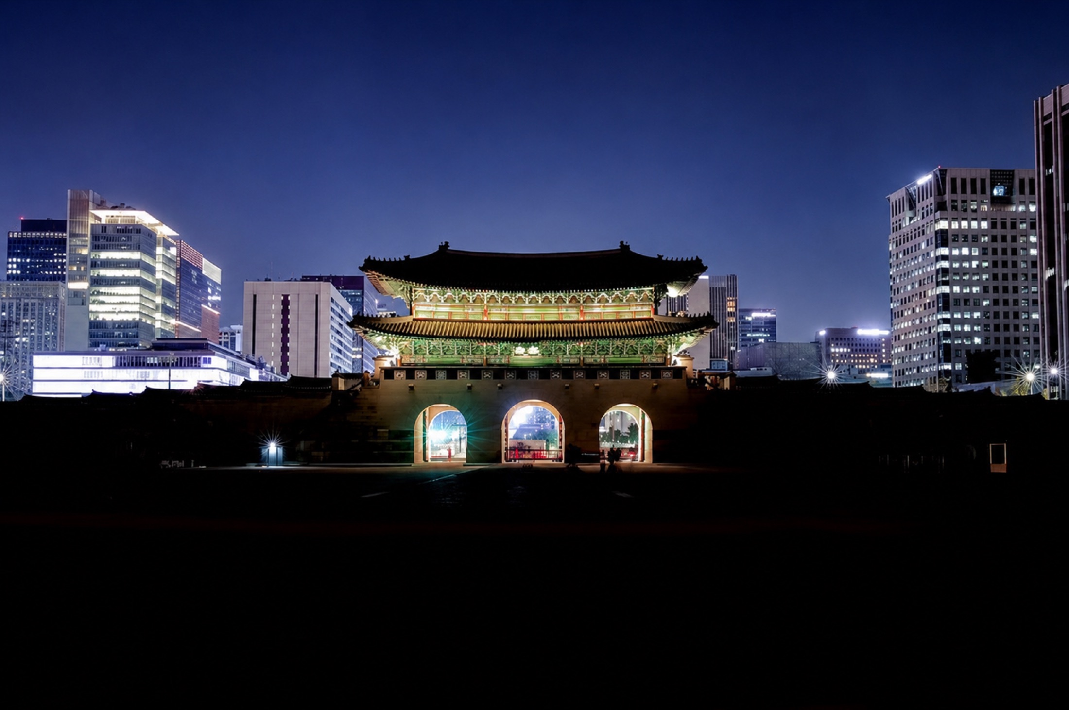 Gwanghwamun gate at night with the Seoul skyline